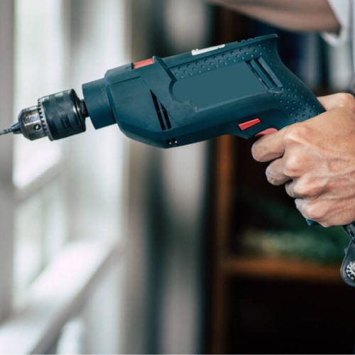 the-carpenter-holds-the-drill-and-drills-the-windo-2021-08-31-12-07-23-utc.jpg